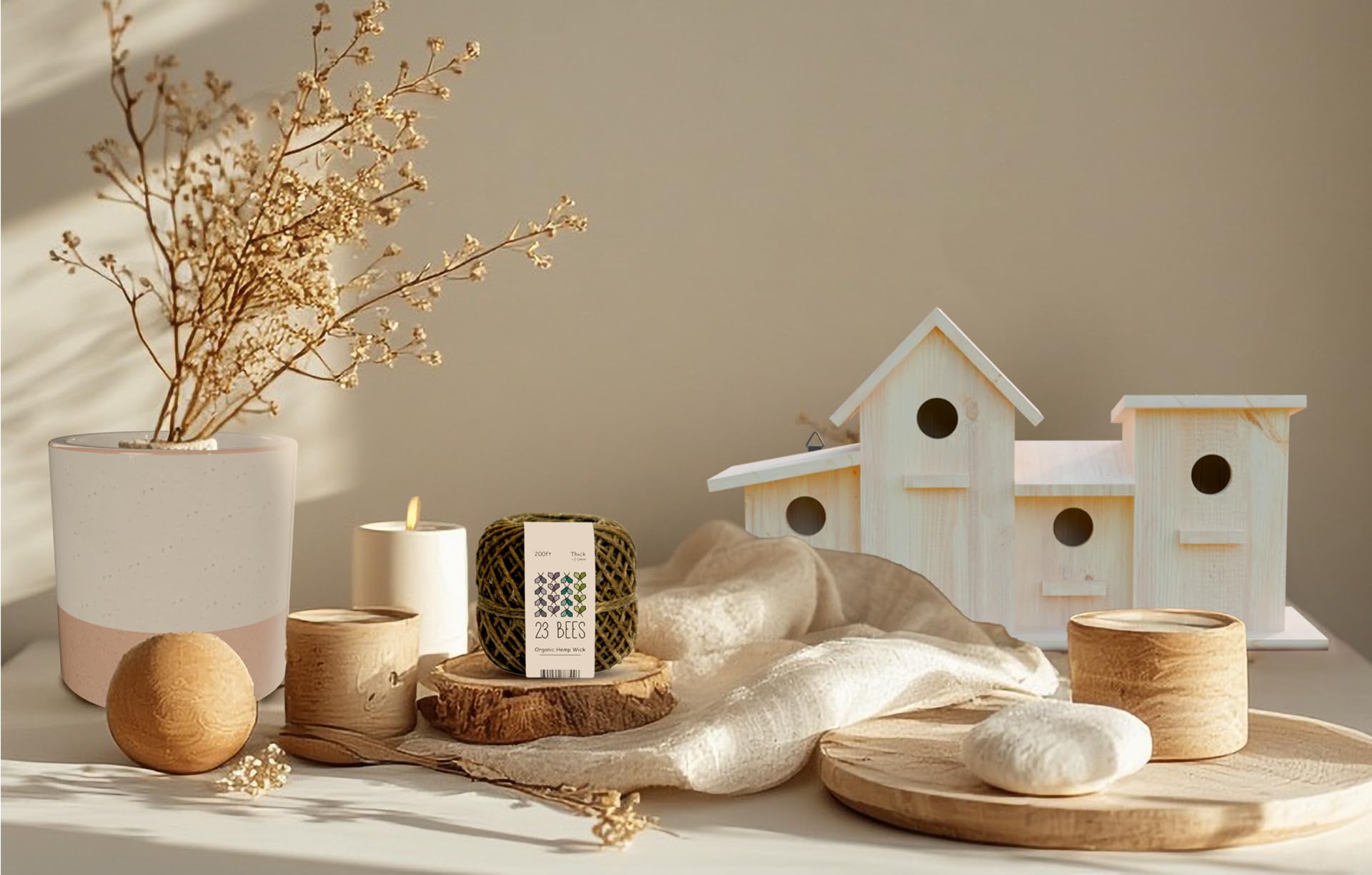 23 BEES organic hemp wick, wooden birdhouses, and candle making supplies on a sunlit table